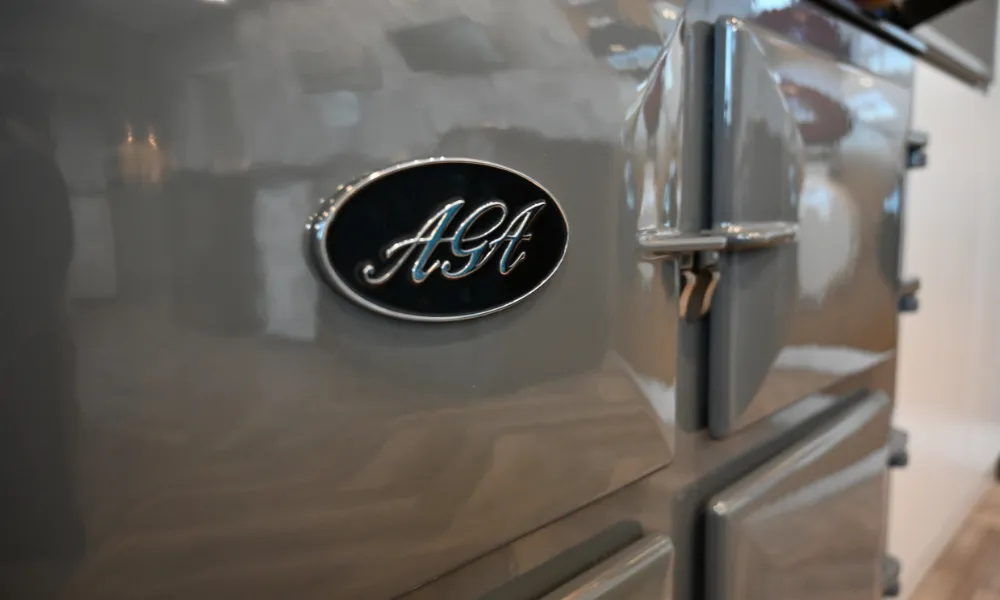 Close up of an Aga cookers badge on a slate grey electric aga cooker